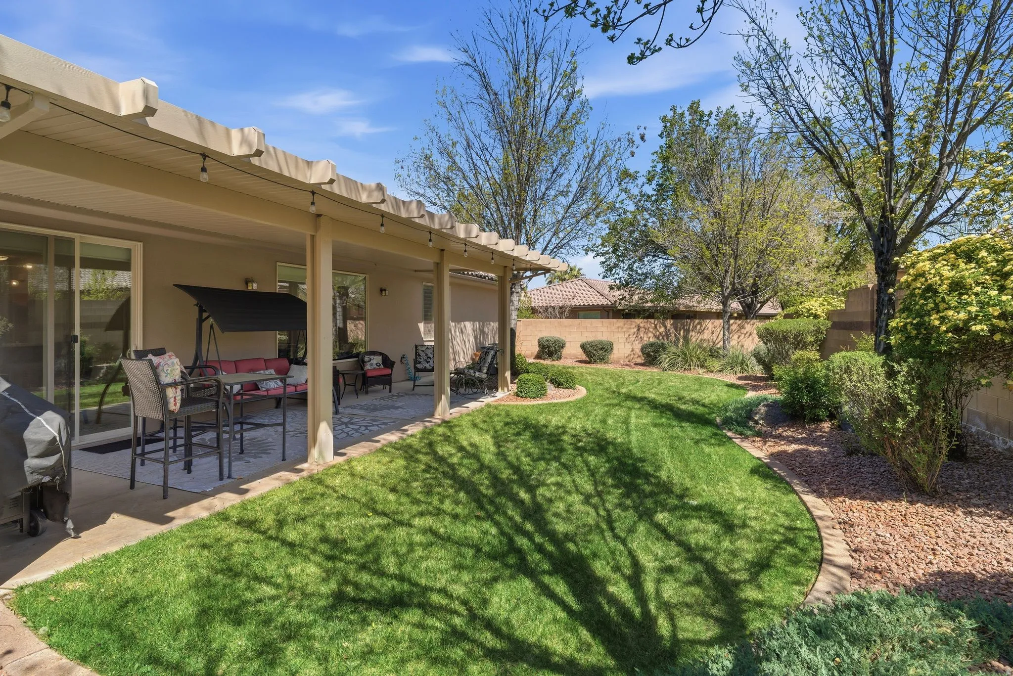 Fenced backyard with a patio and outdoor lounge area