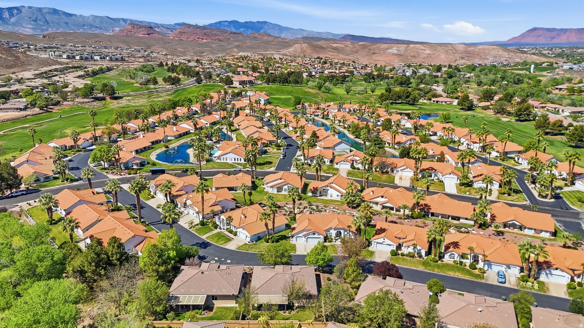 Aerial view of property and surrounding area featuring a water and mountain view and nearby suburban area