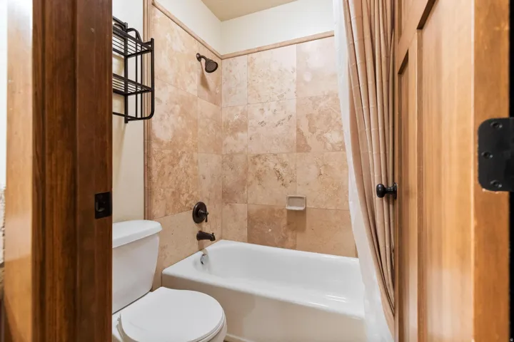Full bathroom featuring toilet and shower / bath combo