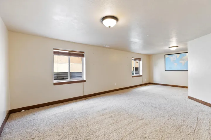 Spare room with plenty of natural light and light colored carpet