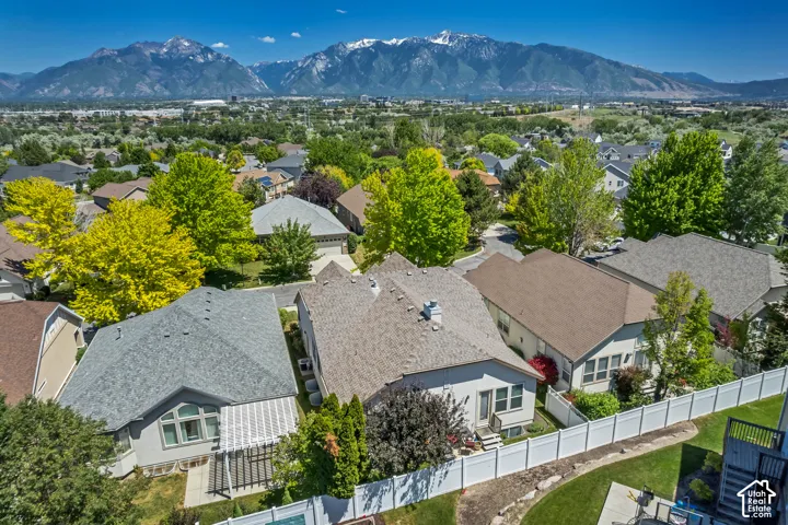 Residential neighborhood with mature trees and mountain scenery
