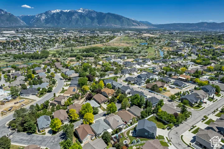 Residential area featuring a diverse collection of single-family homes, mature trees, and paved roadways
