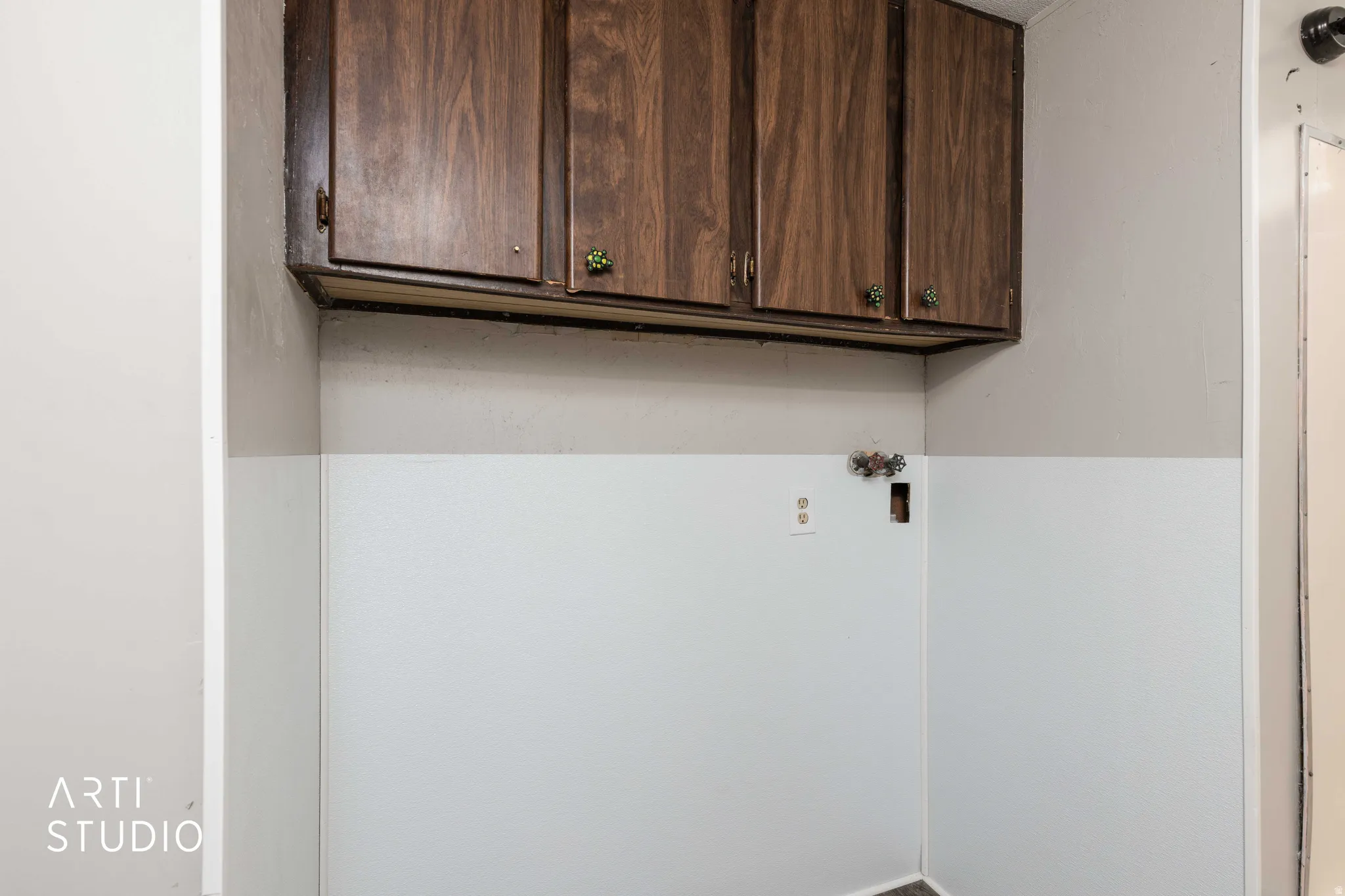 Laundry room featuring washer hookup and cabinet space