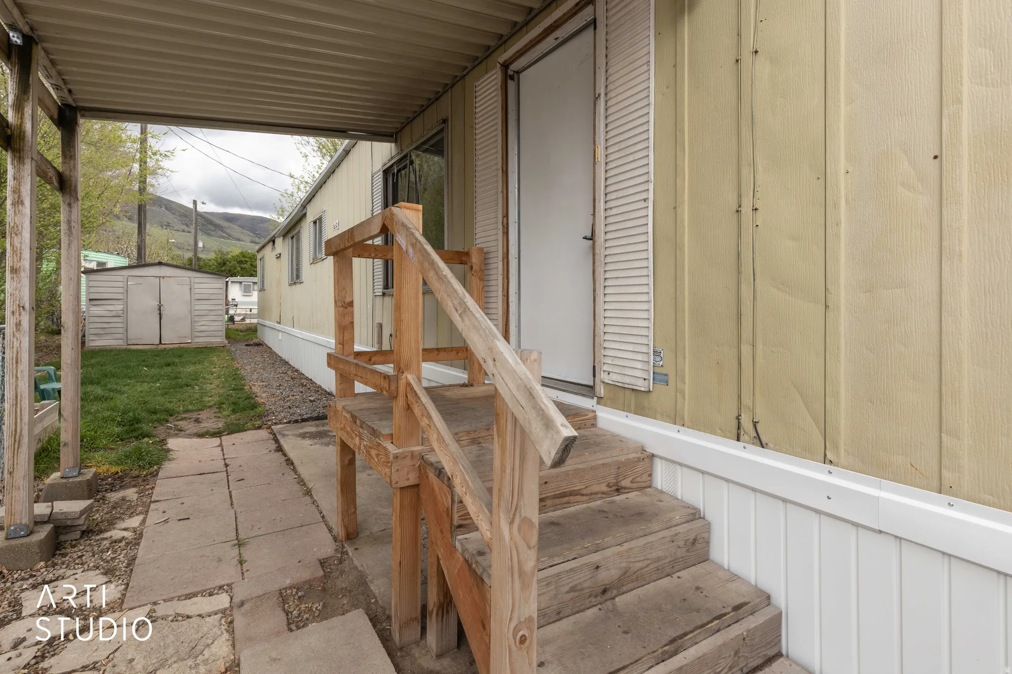 View of patio / terrace featuring a storage unit and a mountain view