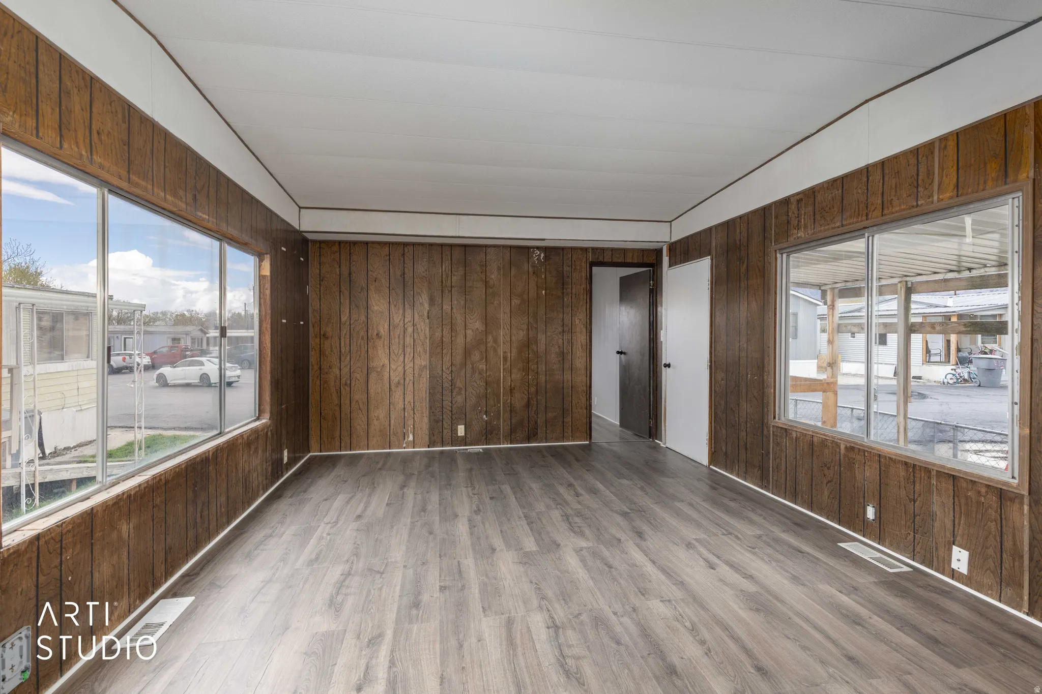 Empty room featuring wooden walls and wood finished floors