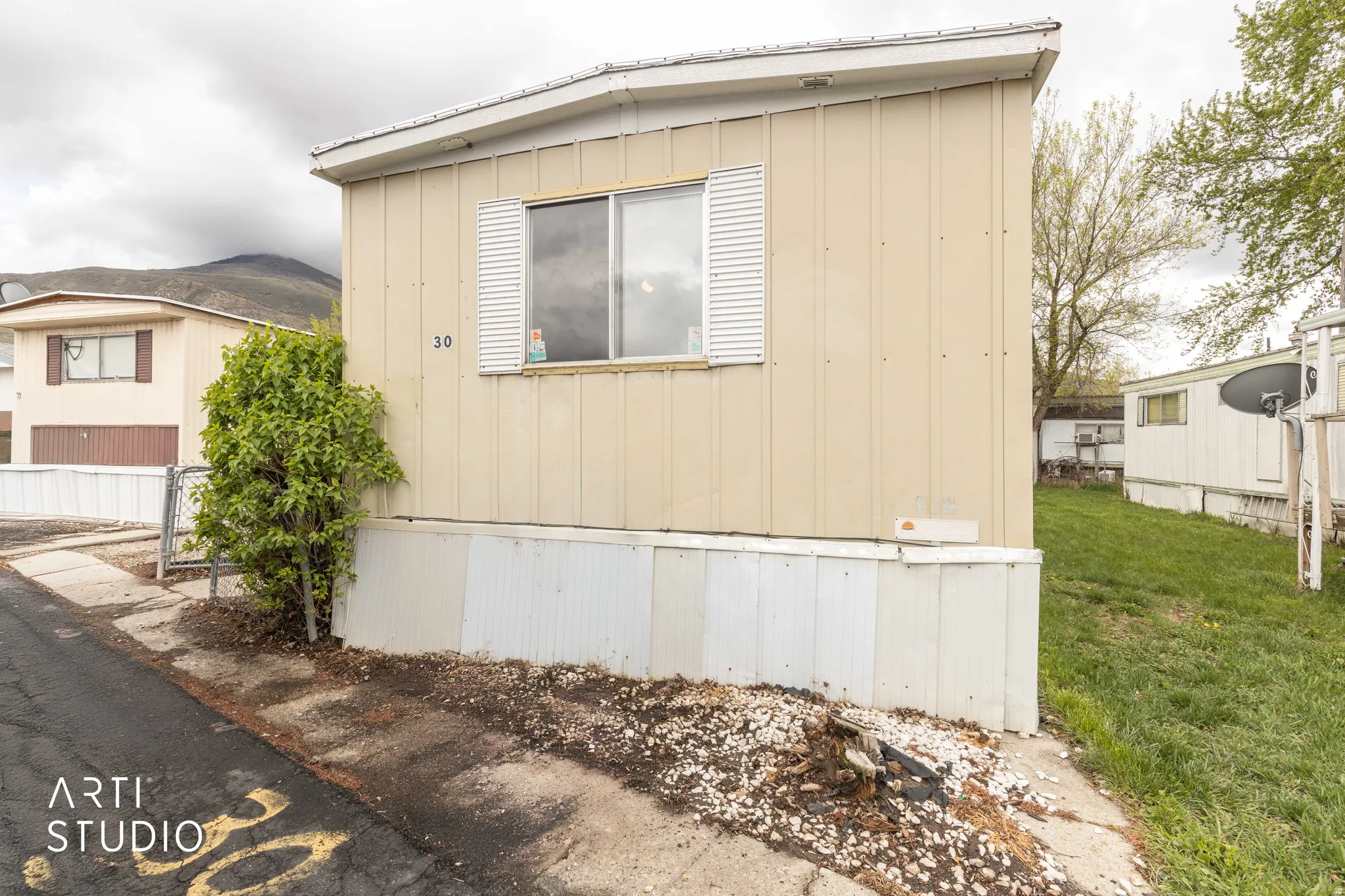 View of side of home with a yard