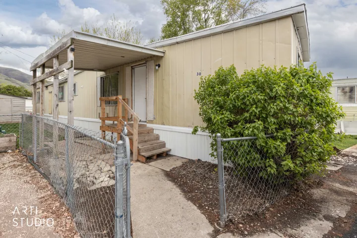 View of front of house with a fenced front yard and a gate