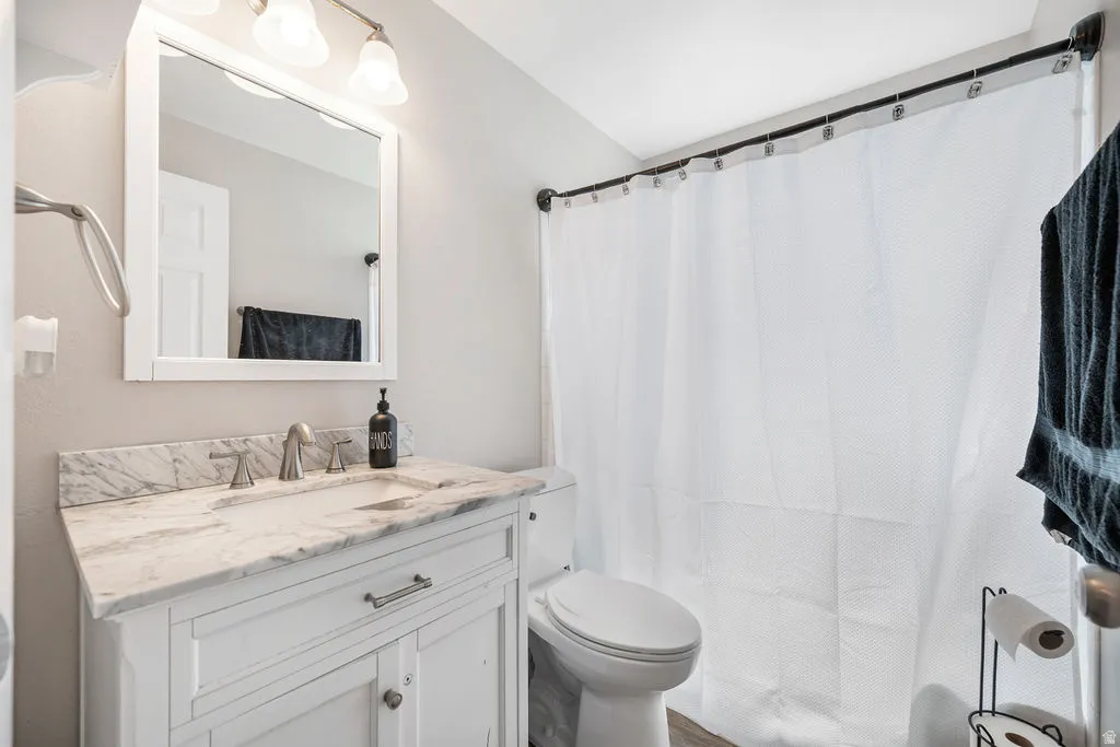 Bathroom with vanity and a shower with shower curtain