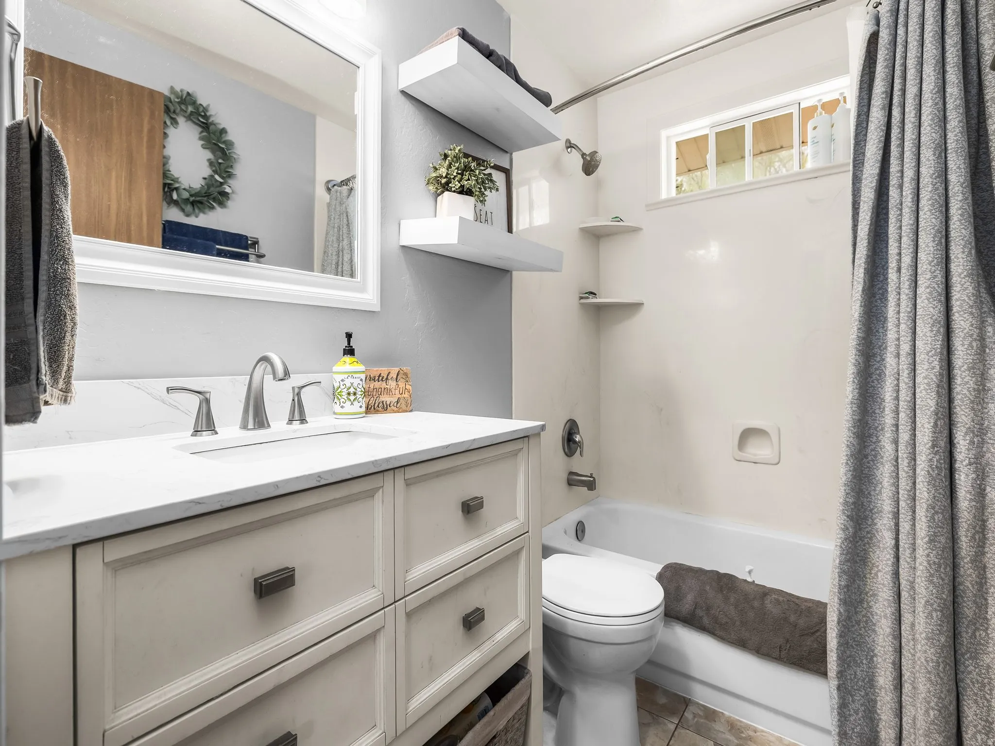 Bathroom with vanity and shower / bath combo