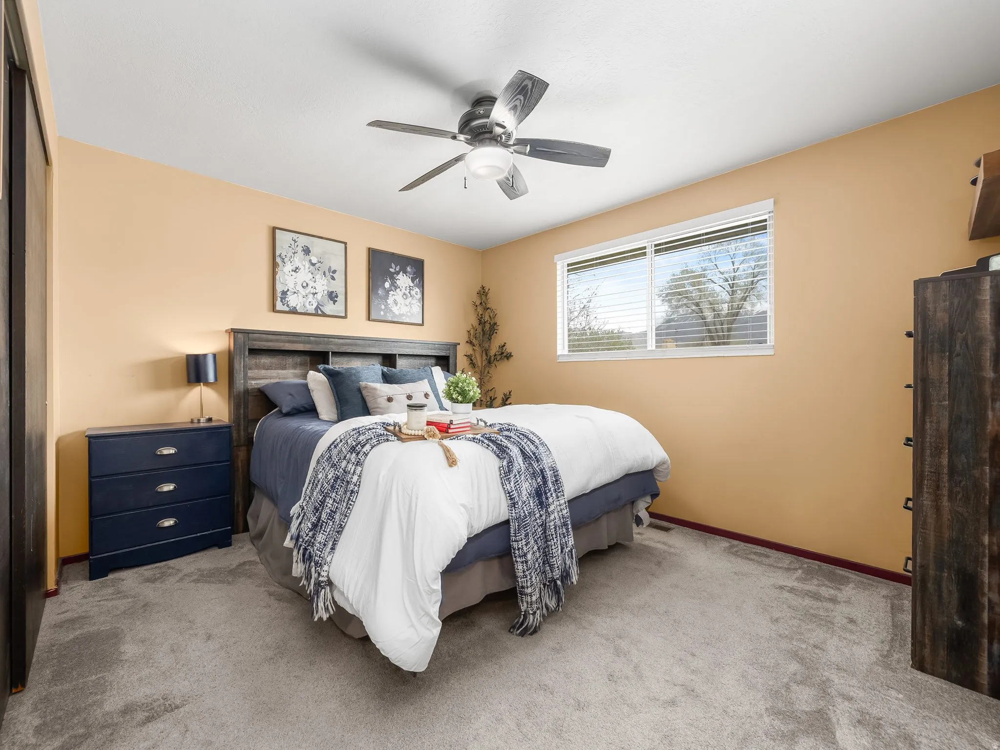 Bedroom with carpet floors and a ceiling fan