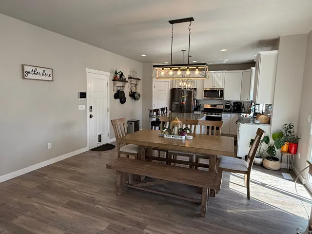 Dining space featuring dark wood-type flooring and recessed lighting
