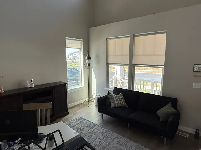 Living area with wood finished floors and baseboards