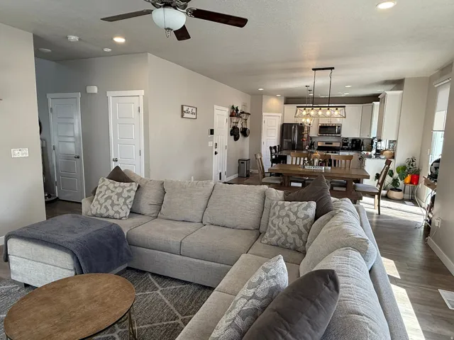 Living area with dark wood finished floors, recessed lighting, and ceiling fan