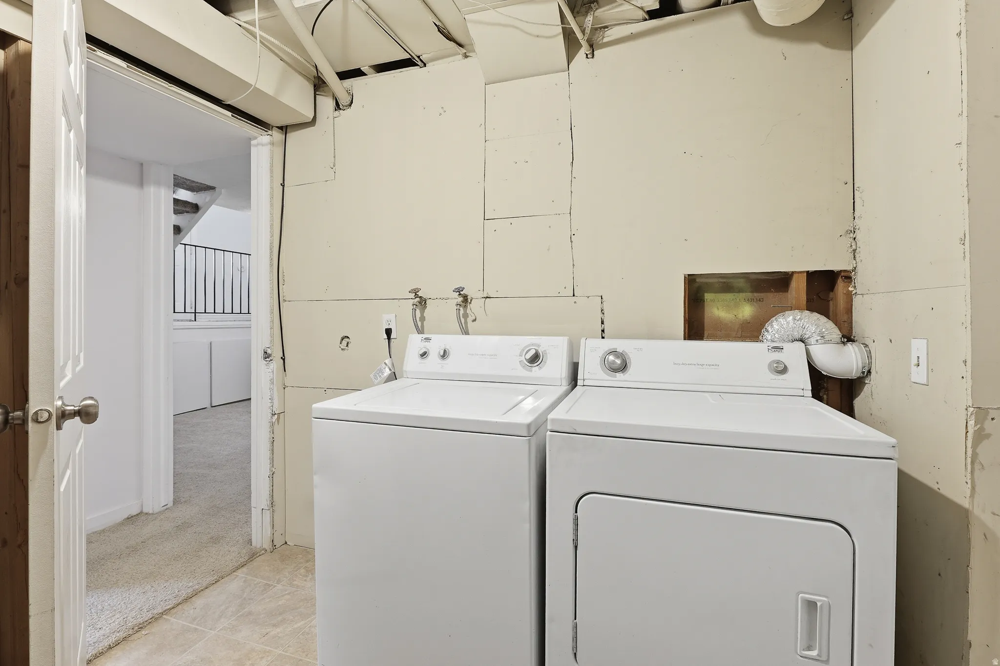 Dedicated laundry area featuring a white washing machine and a white dryer