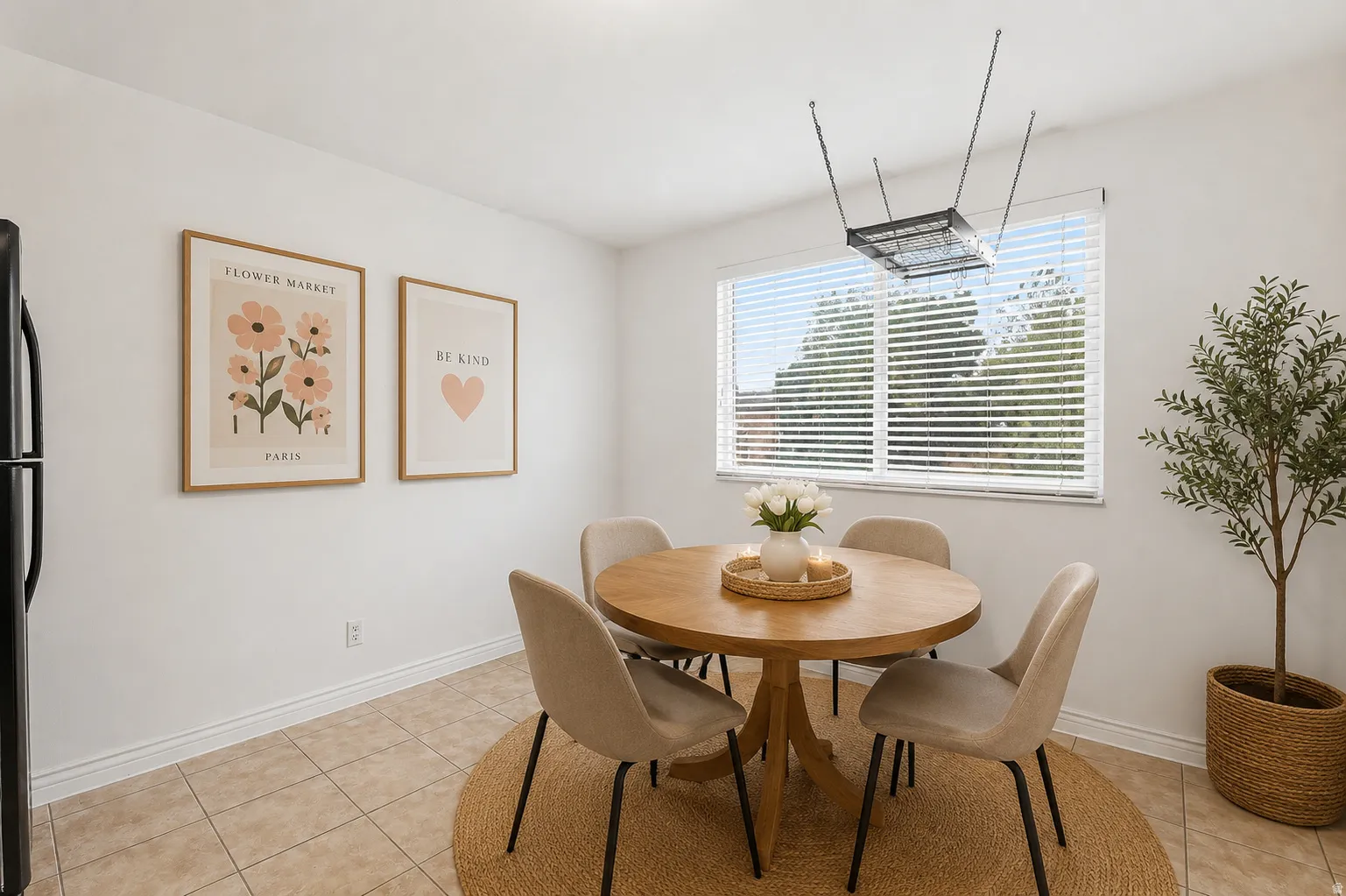 Dining area featuring tile flooring, a large window with blinds, and a built-in ceiling light fixture