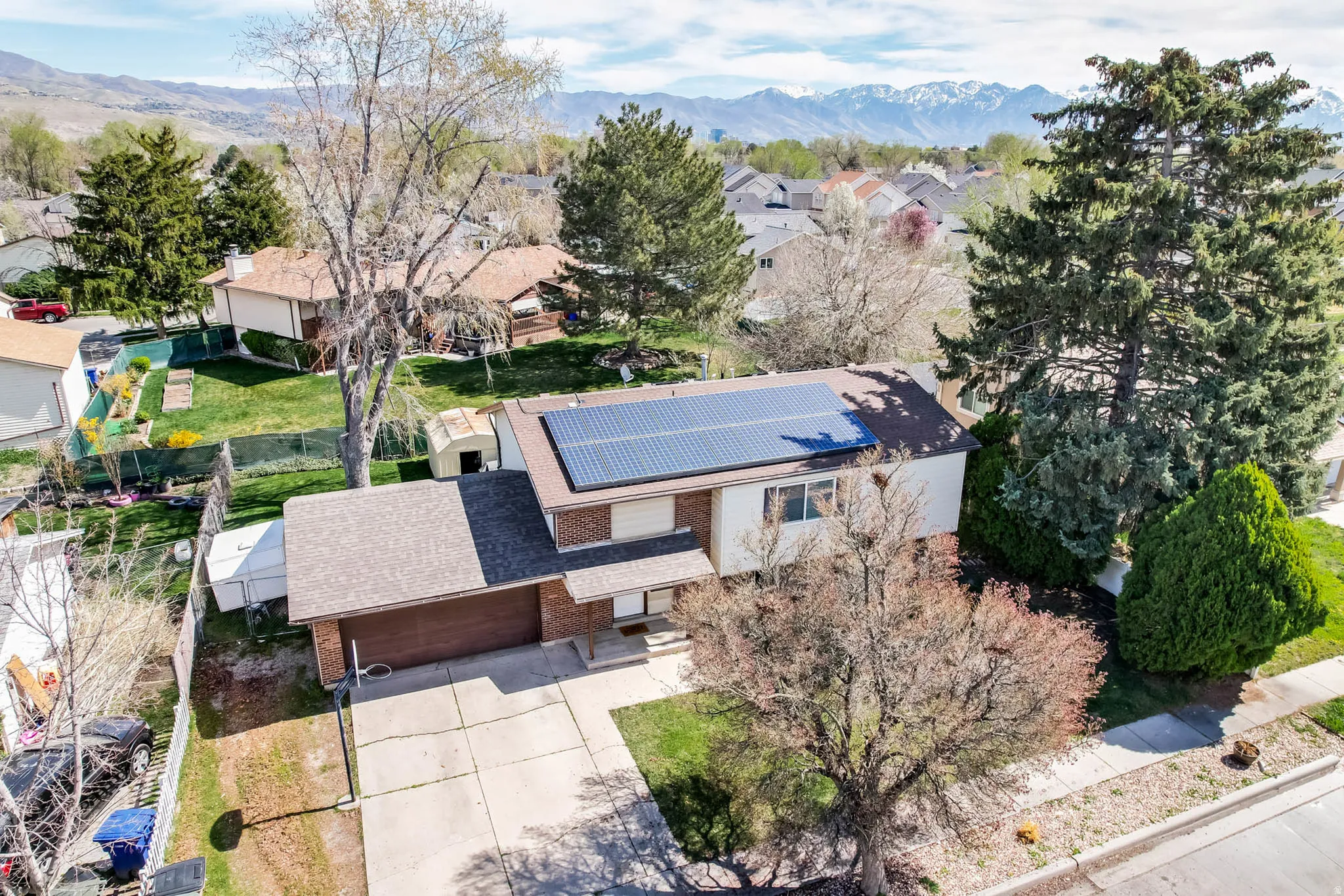 Aerial perspective of suburban area featuring a mountainous background