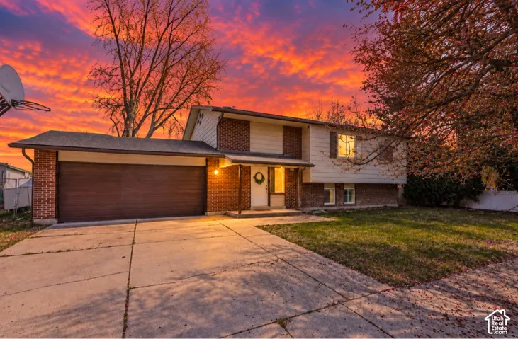 Two-story residence featuring brick and siding exterior, an attached two-car garage, and a concrete driveway