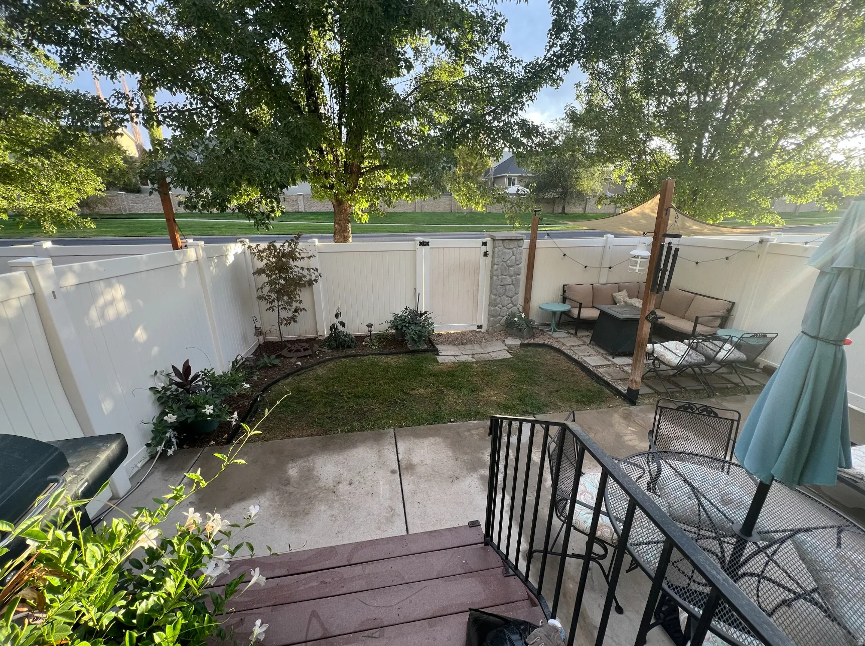 How the backyard previously looked and could look with new plants. Sunshade is included with sale.