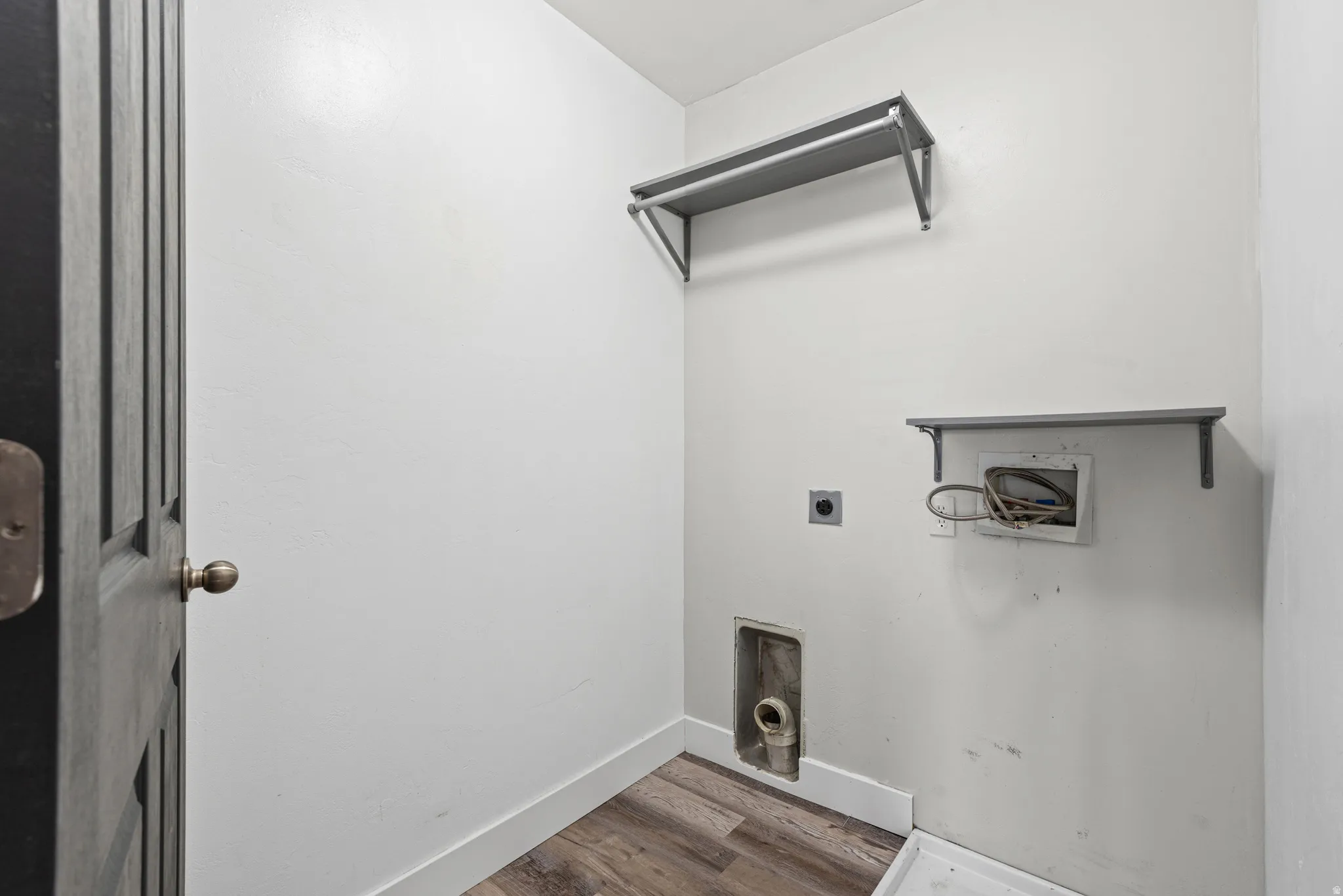 Laundry room with hookup for a washing machine, dark wood-style floors, and hookup for an electric dryer