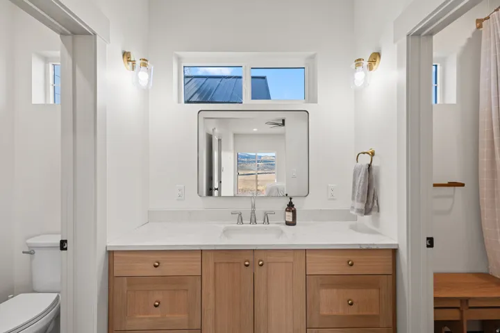 Full bathroom with open vanity area. Doors close off to shower and water closet so multiple people can get ready at once.
