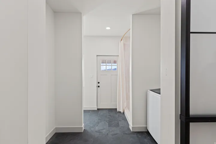 Large laundry room with attached hobby space.