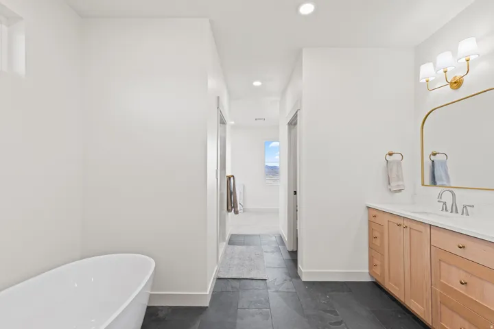 Master Bathroom with separate soaking tub and dual head shower to the left. Water closet is the doorway on the right.