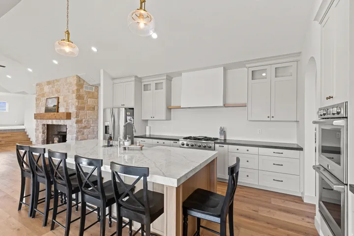 Electric double wall oven and countertop gas range with vent hood.