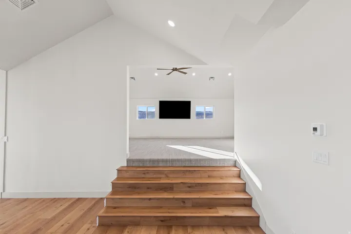 Stairs leading to huge family/media room above RV Garage.
