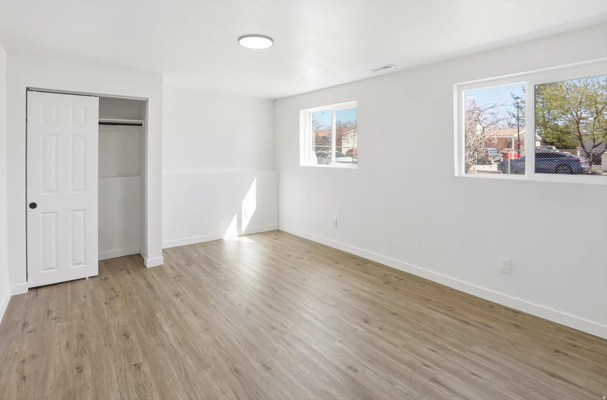 Unfurnished bedroom with a closet and light wood-style flooring
