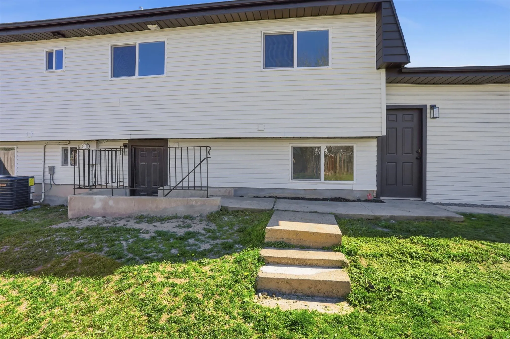 Rear view of house with a lawn
