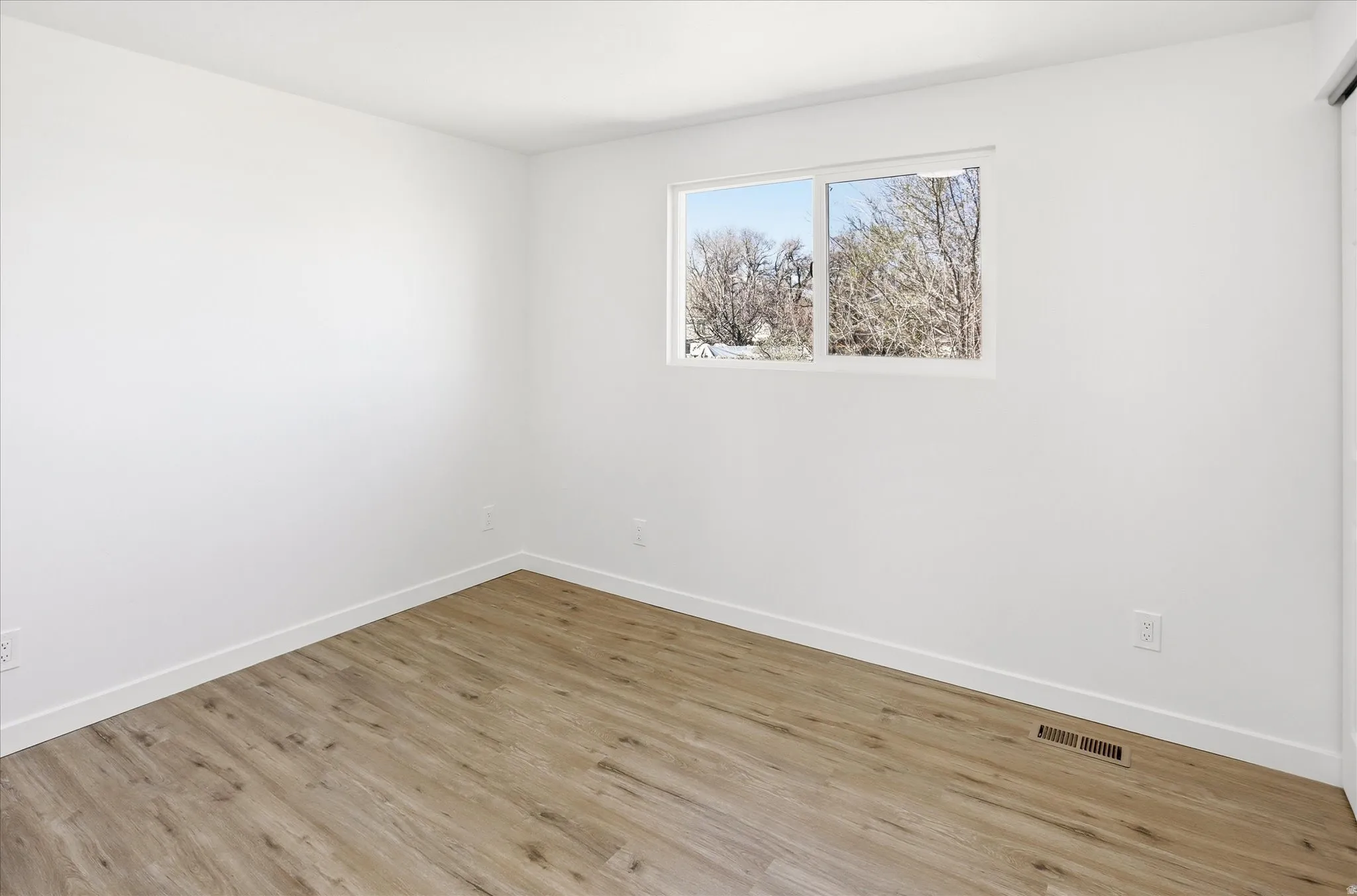 Empty room featuring light wood-style floors