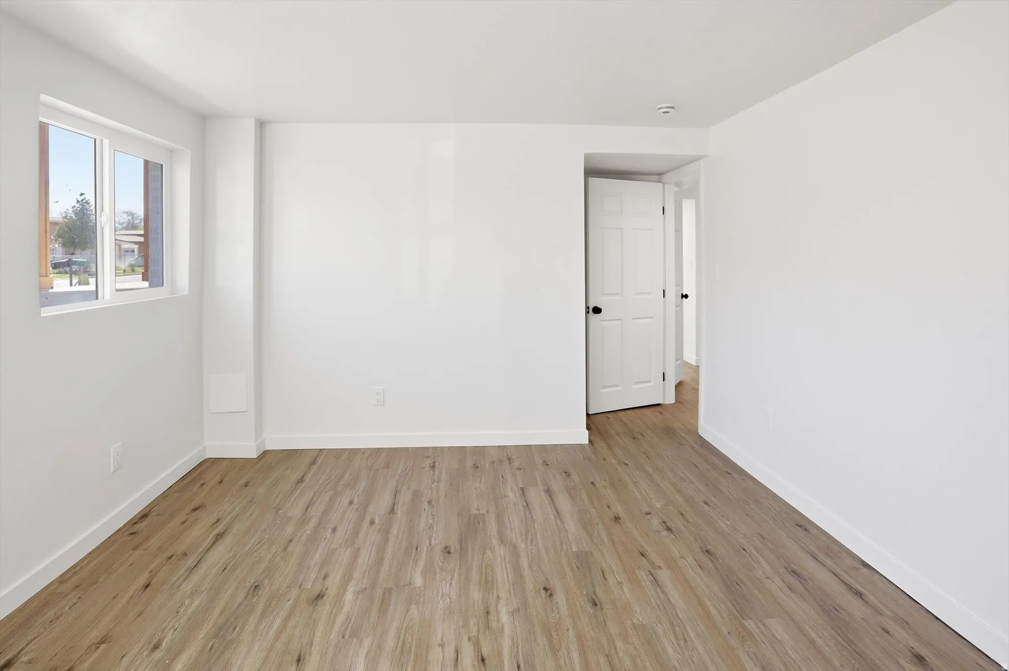 Spare room with light wood-style flooring and baseboards