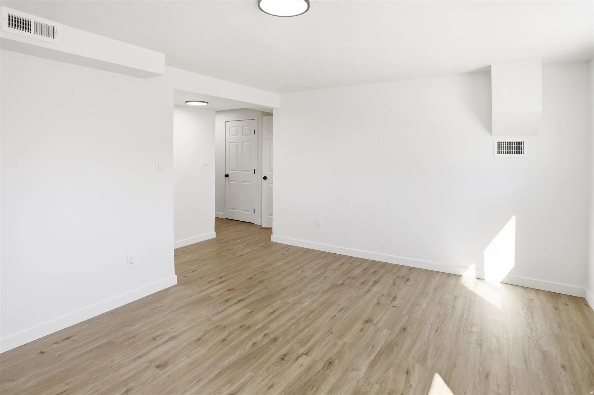 Empty room with light wood-type flooring
