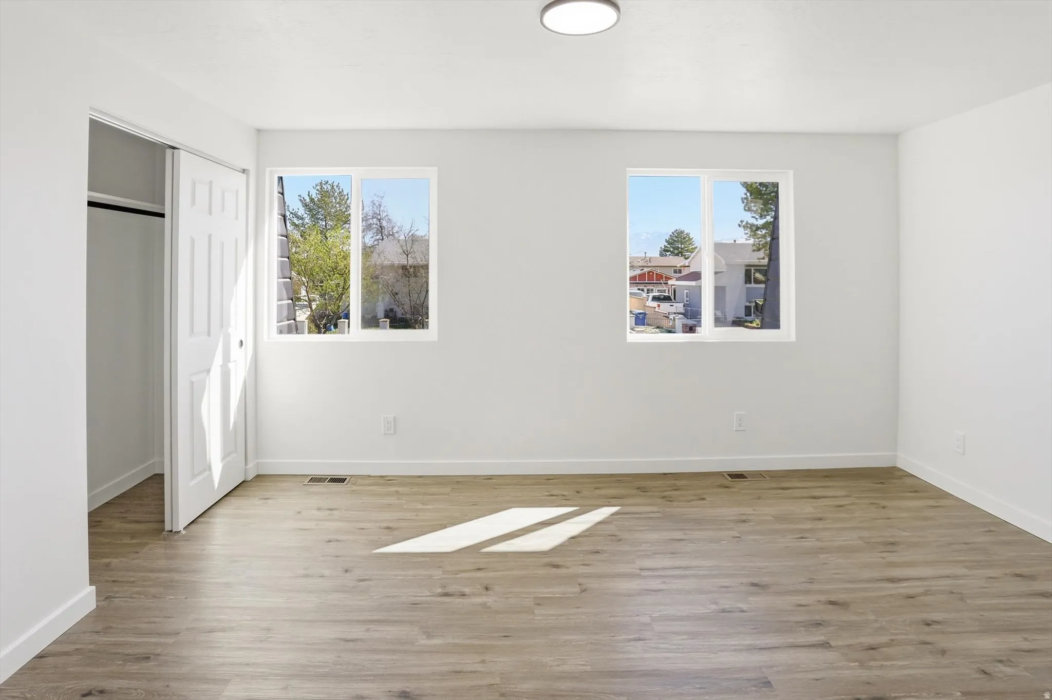 Unfurnished bedroom with light wood finished floors and a closet
