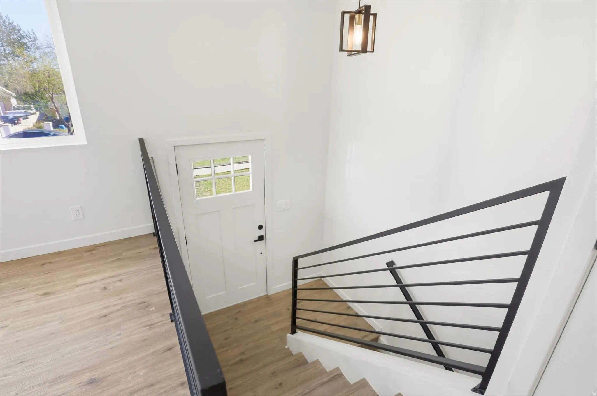 Foyer with stairway and light wood-style floors