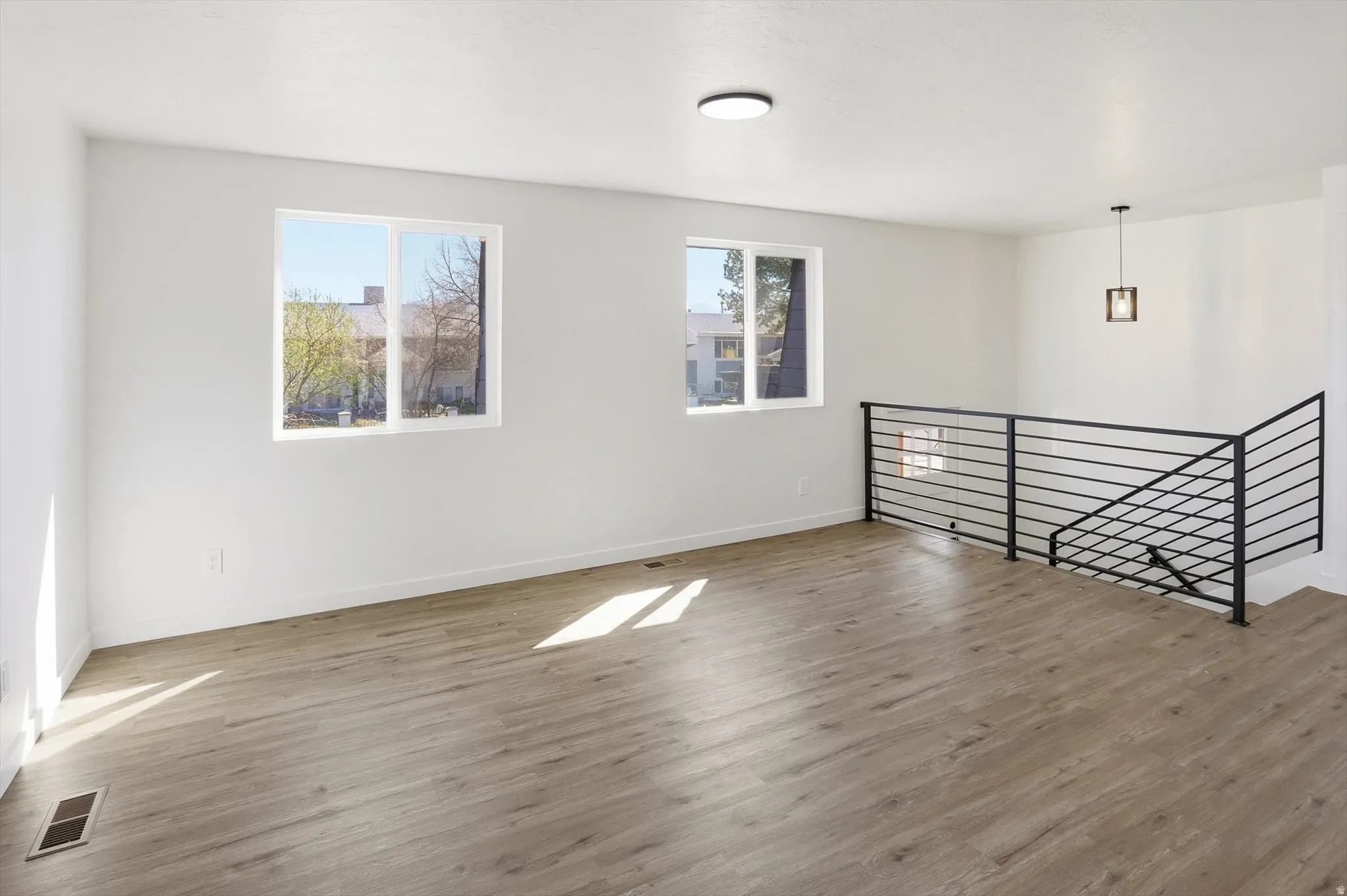 Empty room featuring wood finished floors and baseboards