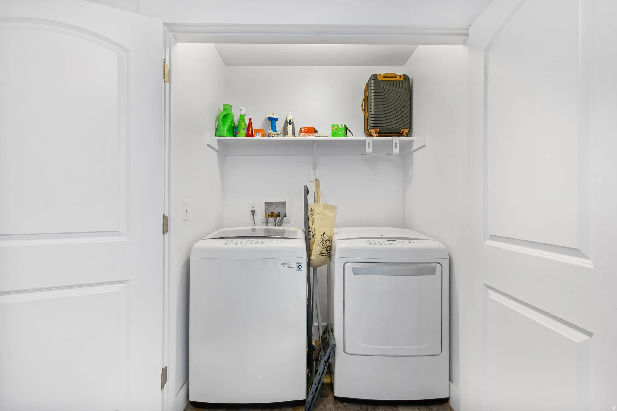 Laundry area with washer and clothes dryer