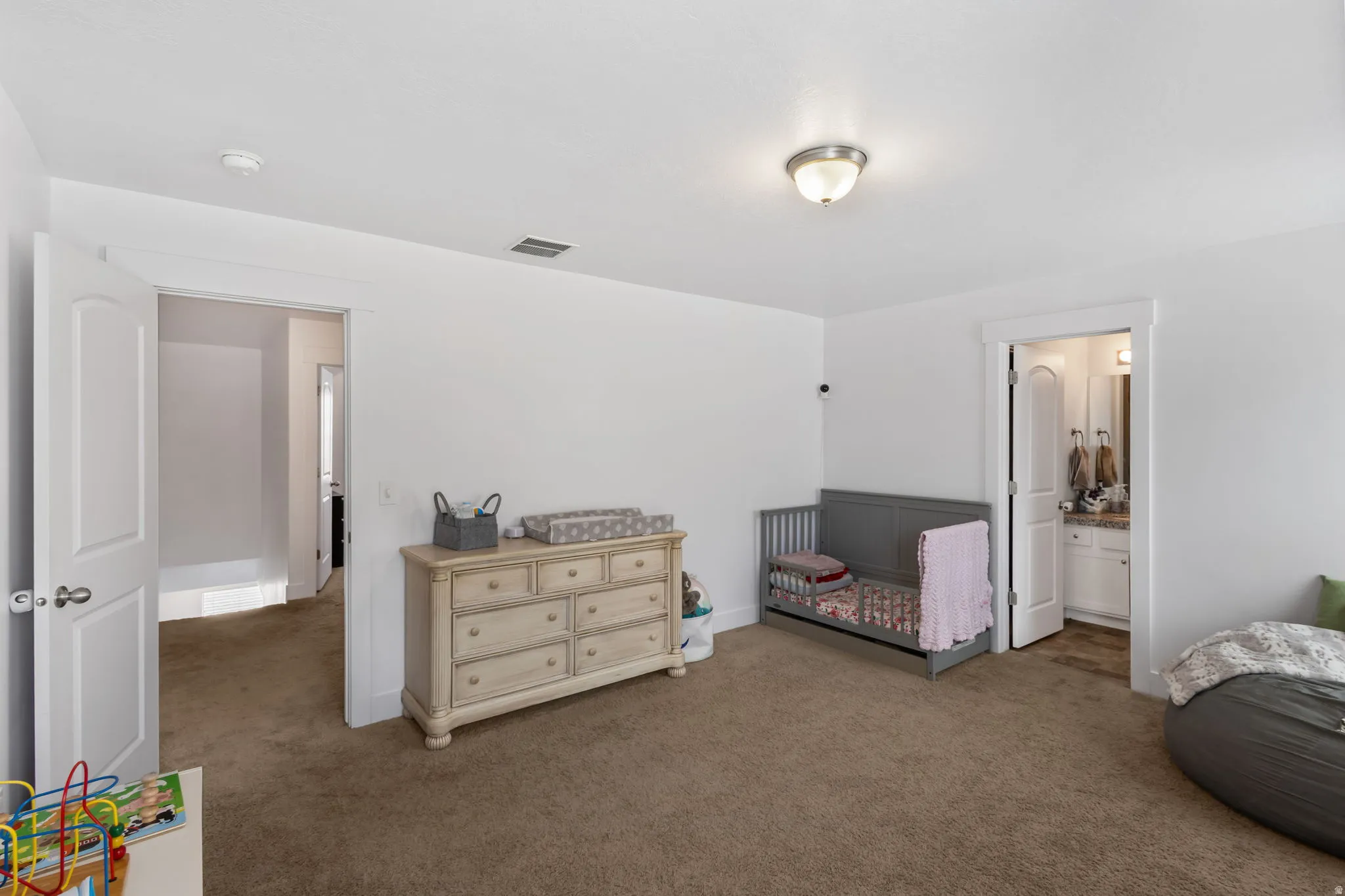 Carpeted bedroom featuring baseboards