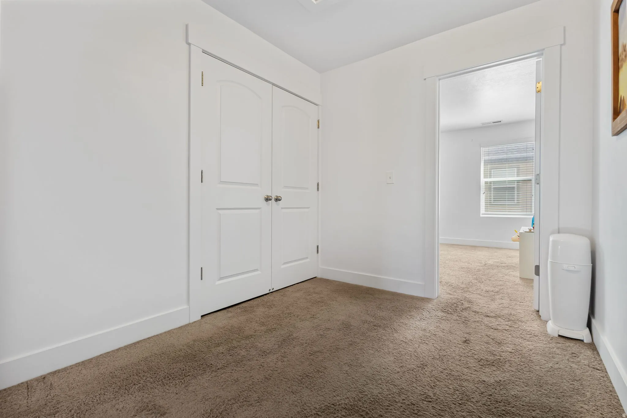 Unfurnished bedroom with carpet floors and a closet