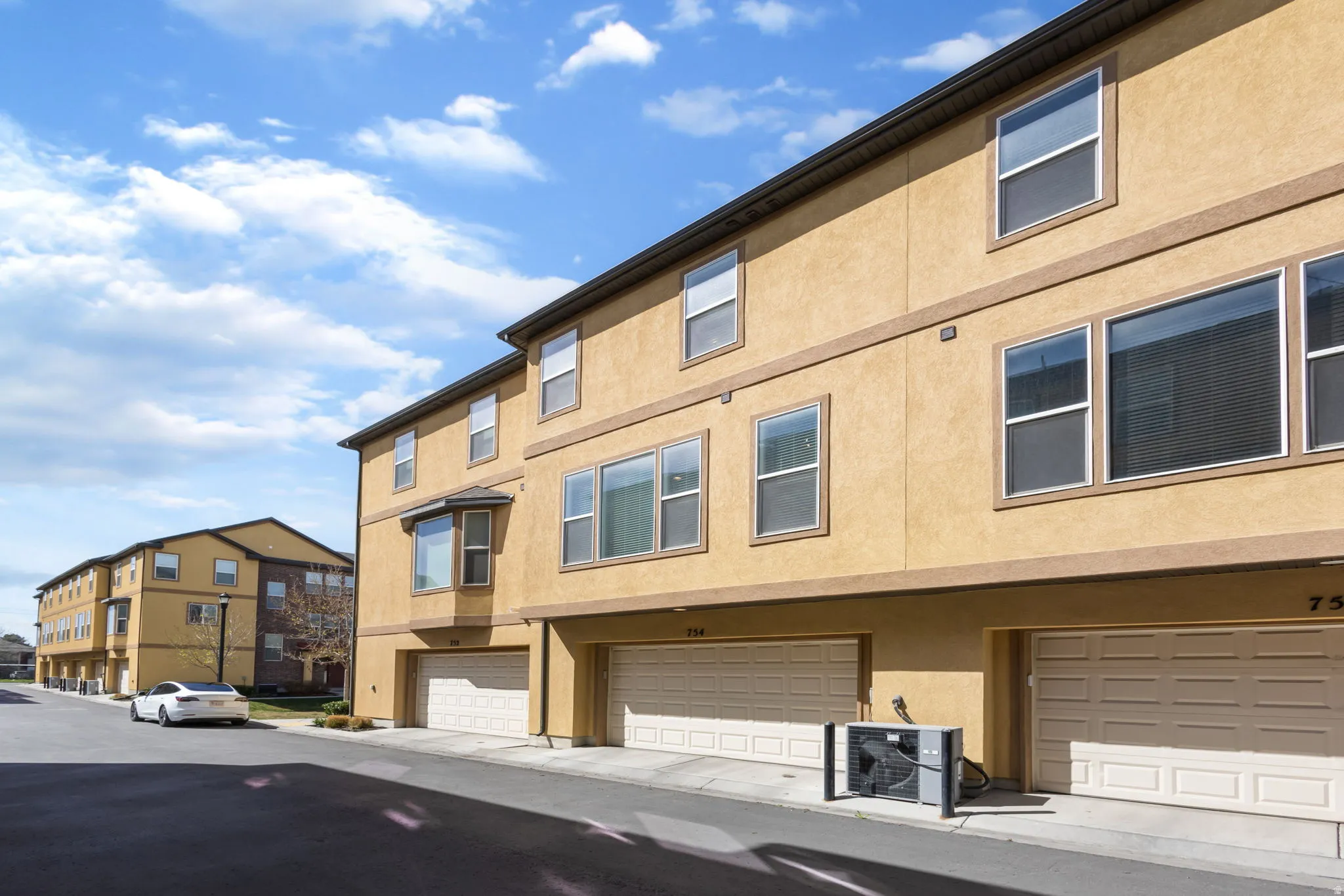 View of property with a residential view and a garage