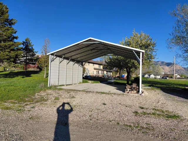 View of parking featuring a carport and a mountain view