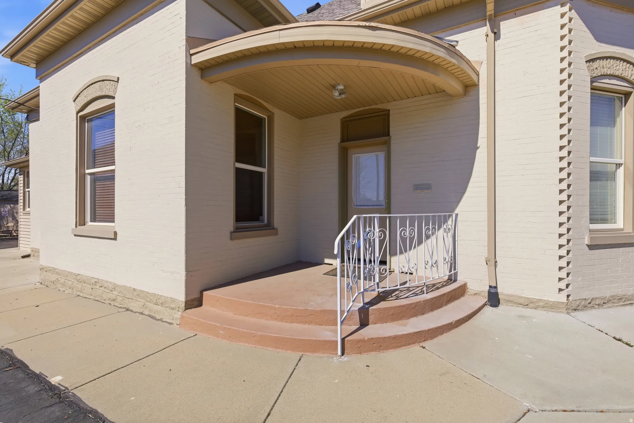 View of exterior entry with brick siding