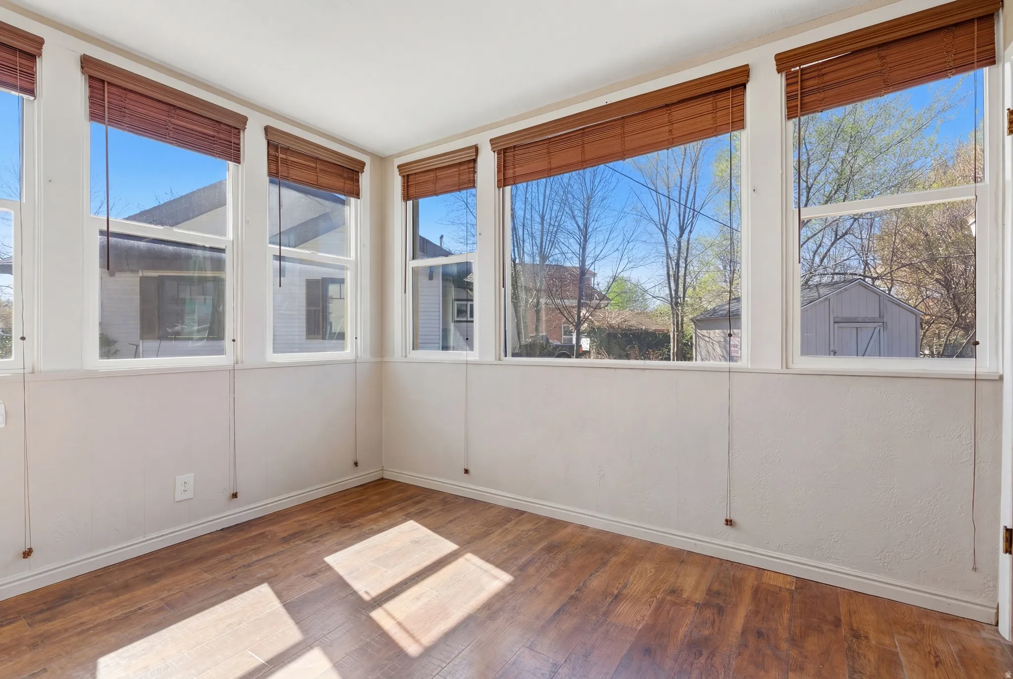 Unfurnished sunroom with wood finished floors