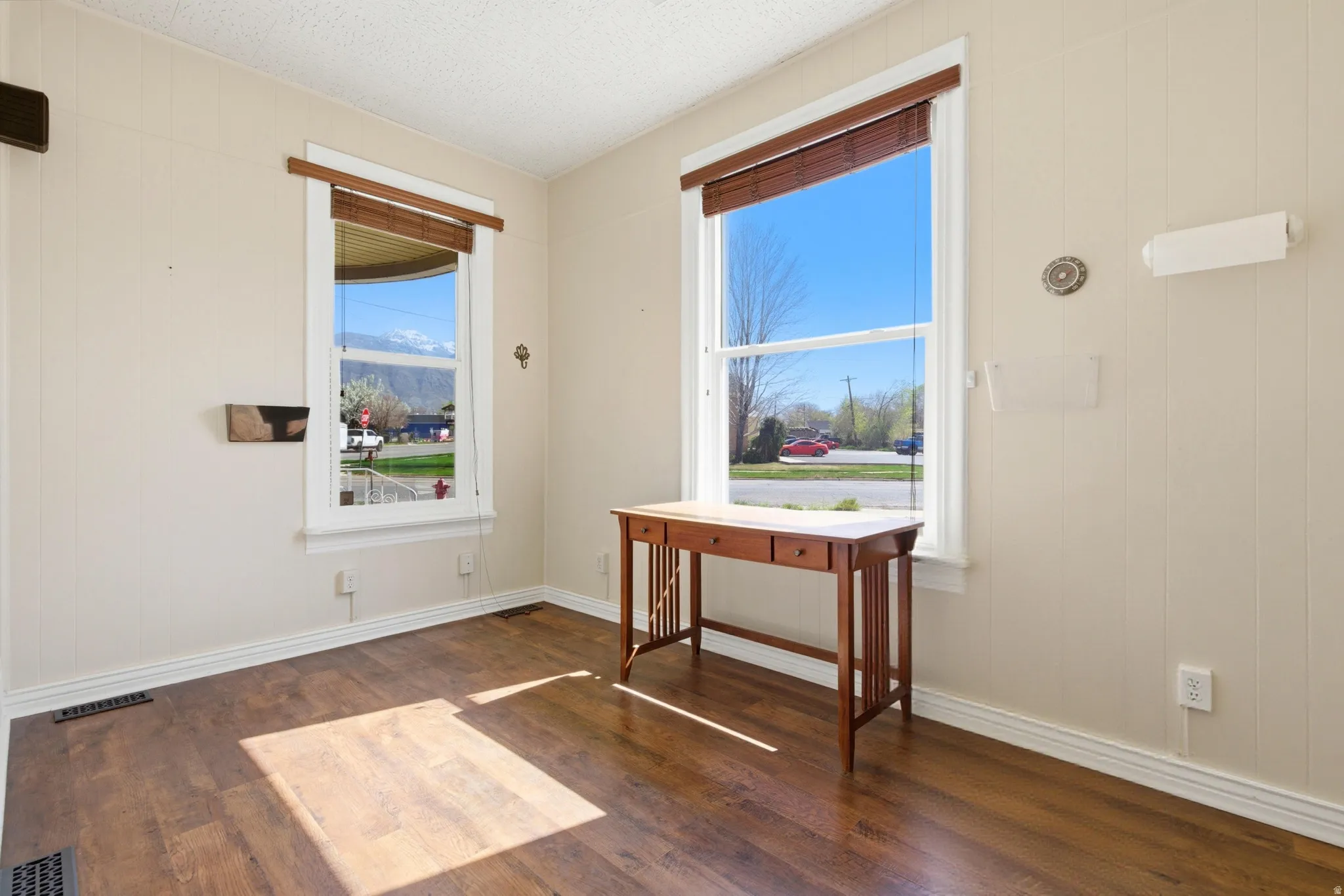 Doorway to outside featuring wood finished floors and baseboards