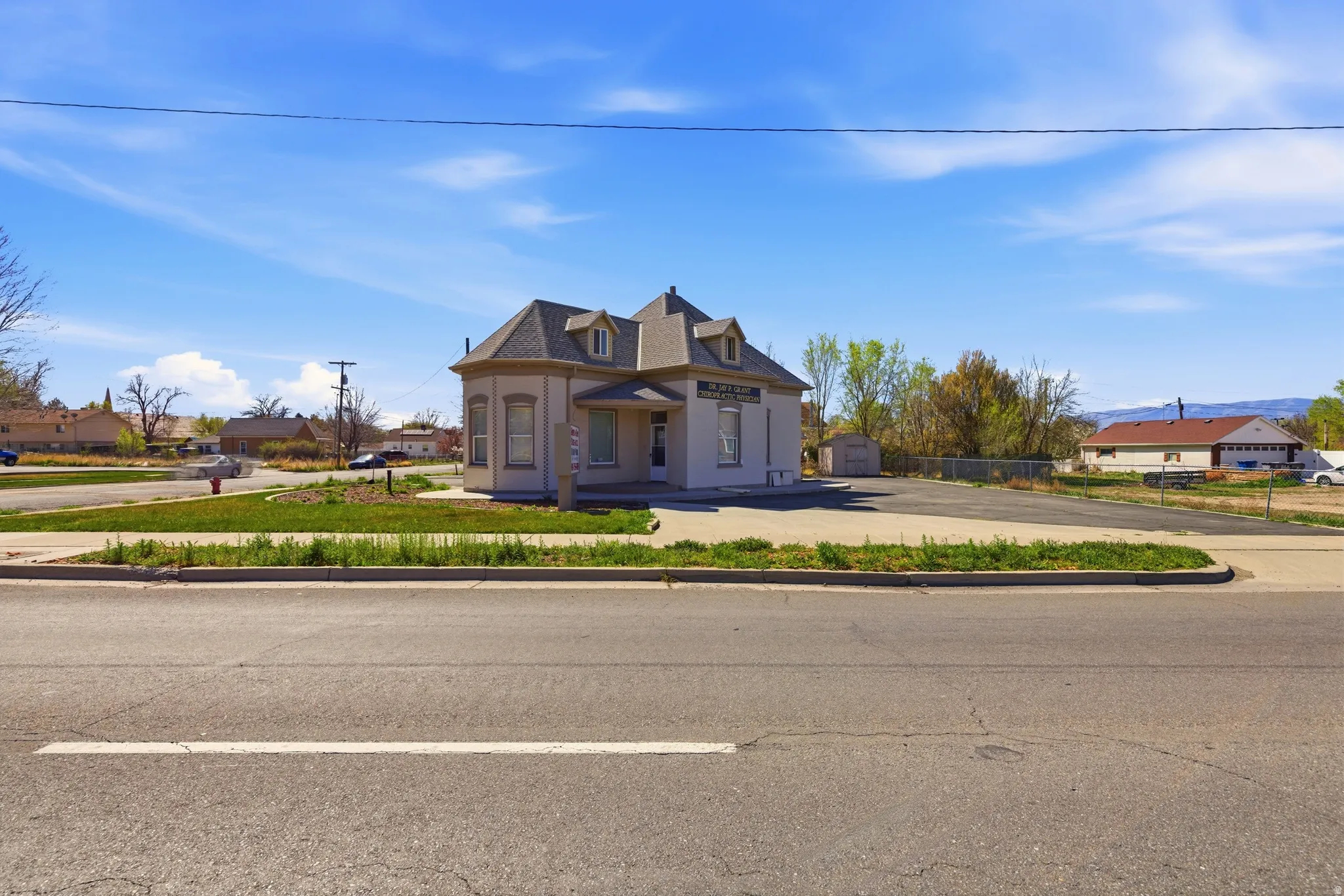 View of front of home with covered porch, a residential view, and a shingled roof