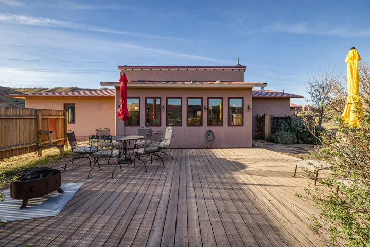 Wooden deck featuring a fire pit and outdoor dining area