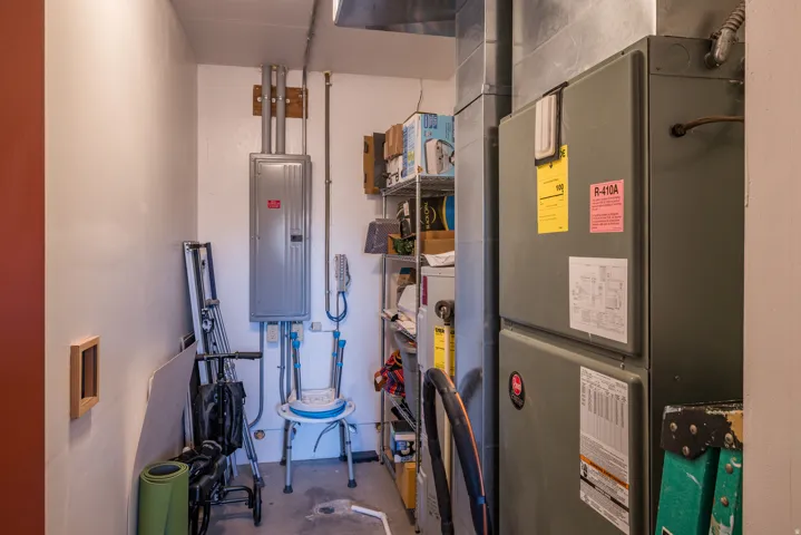 Utilities with electric panel, heating unit, and water heater