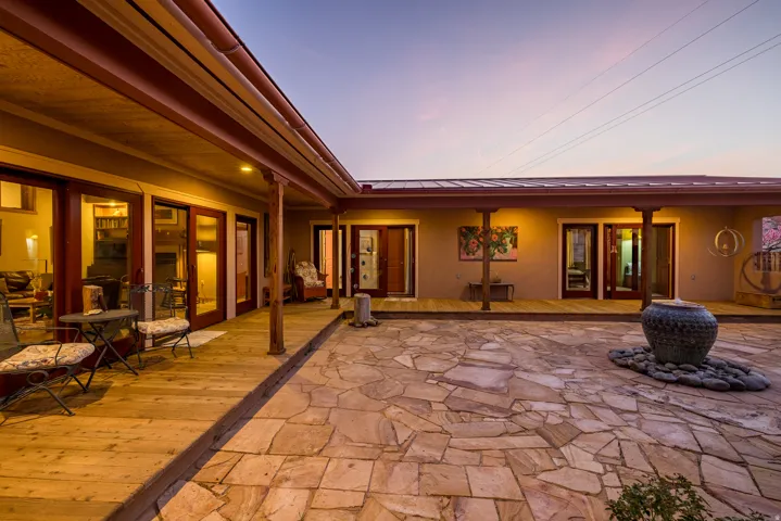 Patio terrace at dusk featuring a patio and a deck