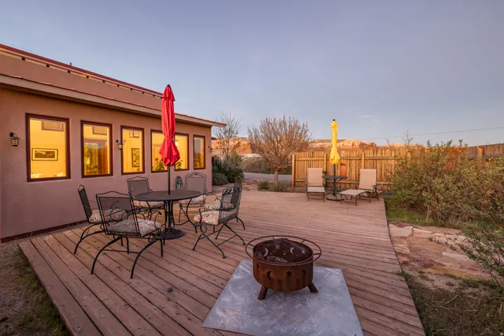 Wooden deck featuring outdoor dining space and an outdoor fire pit
