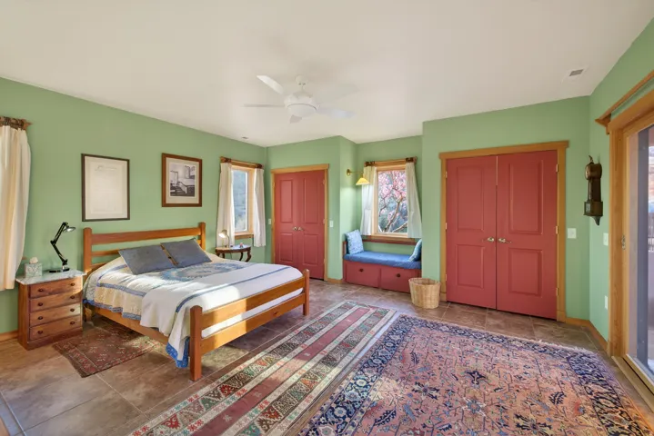 Bedroom featuring multiple closets and a ceiling fan